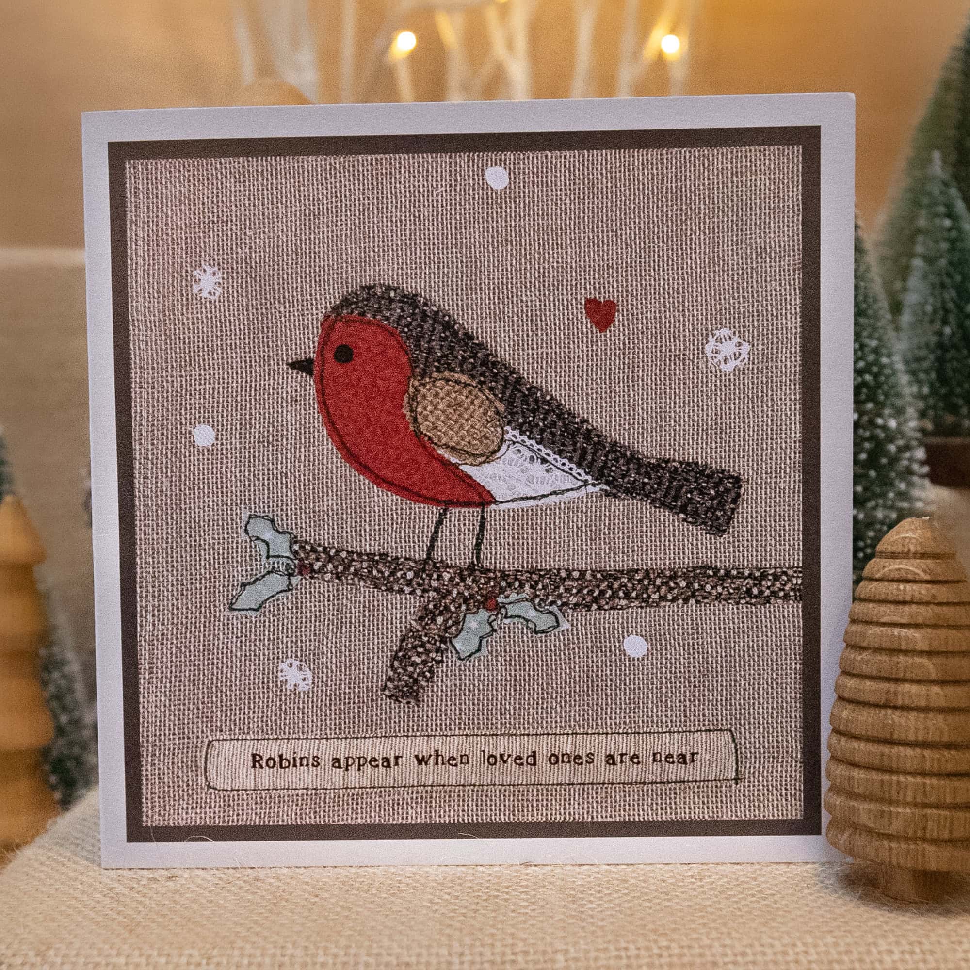 Close-up of a free-motion embroidered robin on linen