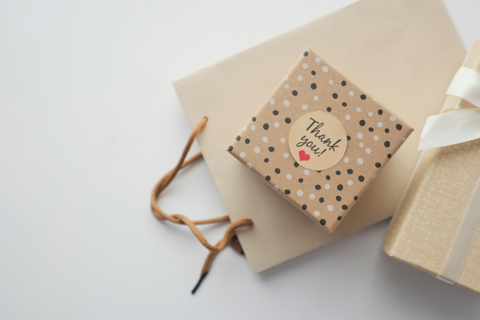 a thank you sticker on a gift box on table with copy space
