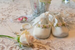 Baby’s baptism items on lace tablecloth