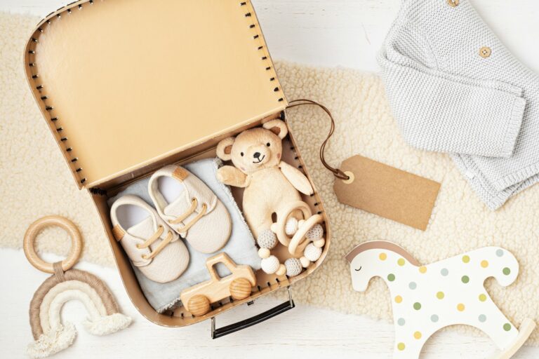 Gift basket with gender neutral baby garment and accessories