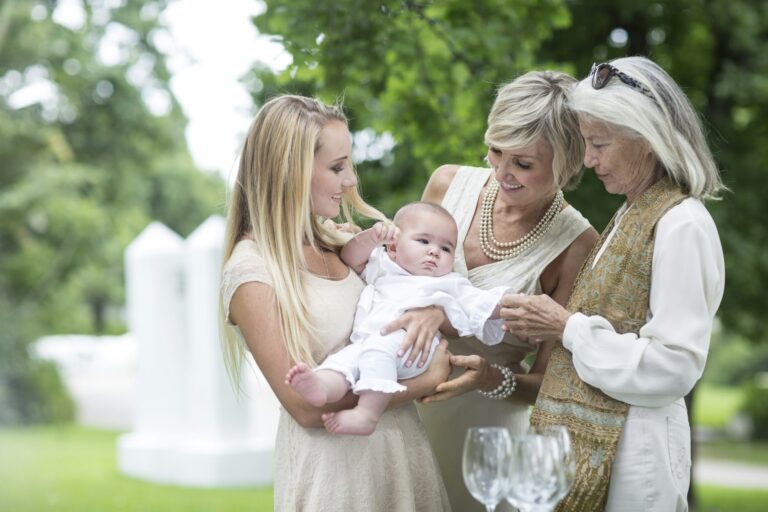 Christening or naming ceremony - Three women gathering around baby celebrating